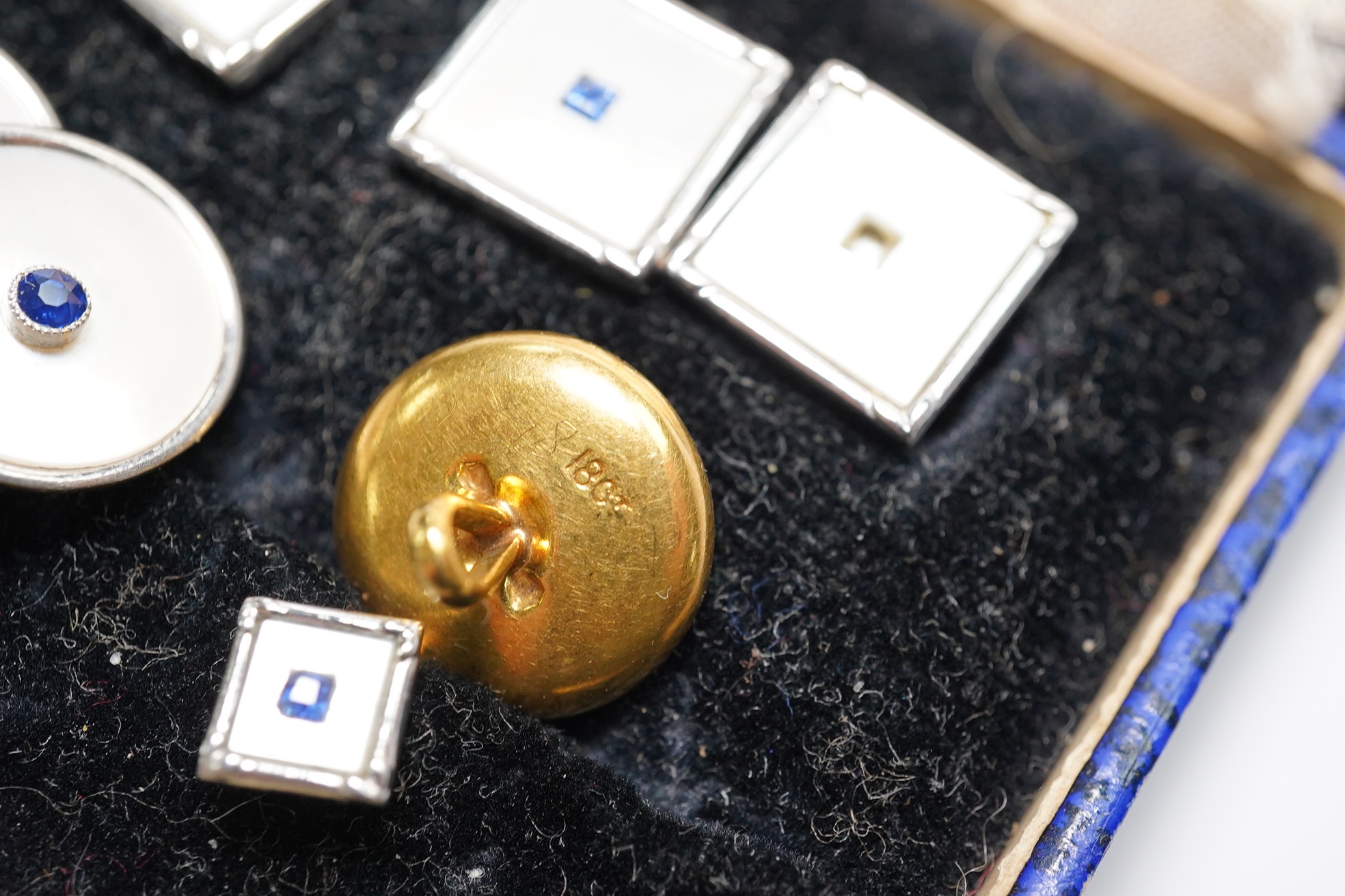 A cased four piece 9ct, mother of pearl and sapphire set dress stud set and three similar 18ct dress studs. Condition - poor to fair